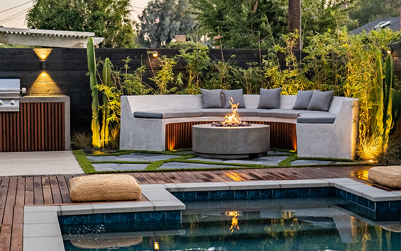 fire with landscaping and seating behind and pool in front