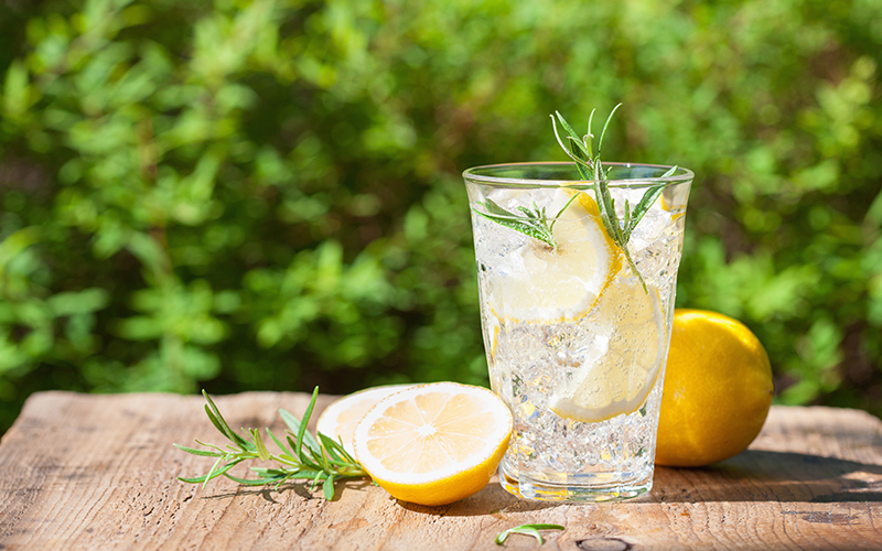 lemons and fresh rosemary near rosemary lemonade drink