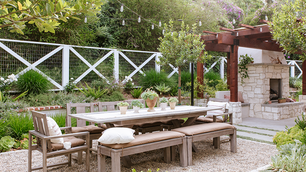 wood dining room table with award-winning landscaped garden
