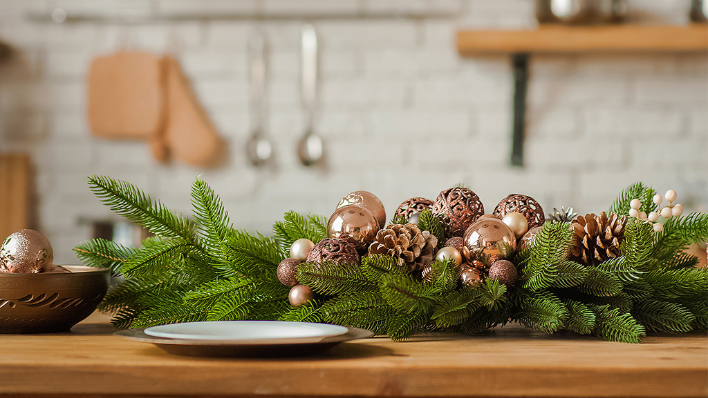 holiday decor with pine bough with gold ornaments