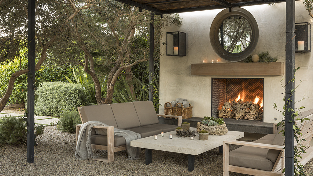 outdoor fireplace with trellis, outdoor furniture and coffee table in front