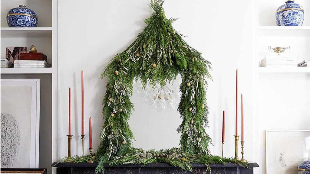 Pagoda-inspired garland around a mirror comprising of Green Sport Western Red Cedar and Little Ollie Dwarf Olive branches.