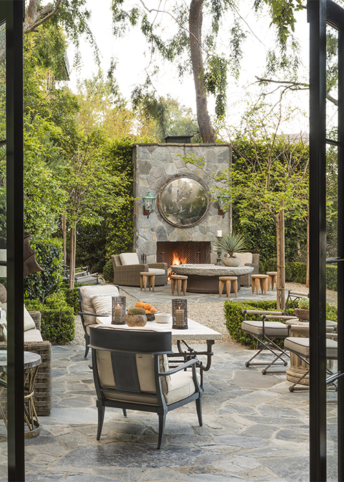 view of outdoor fireplace through french doors