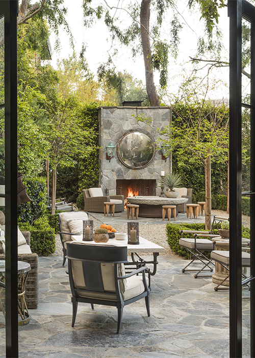 view of outdoor fireplace through french doors