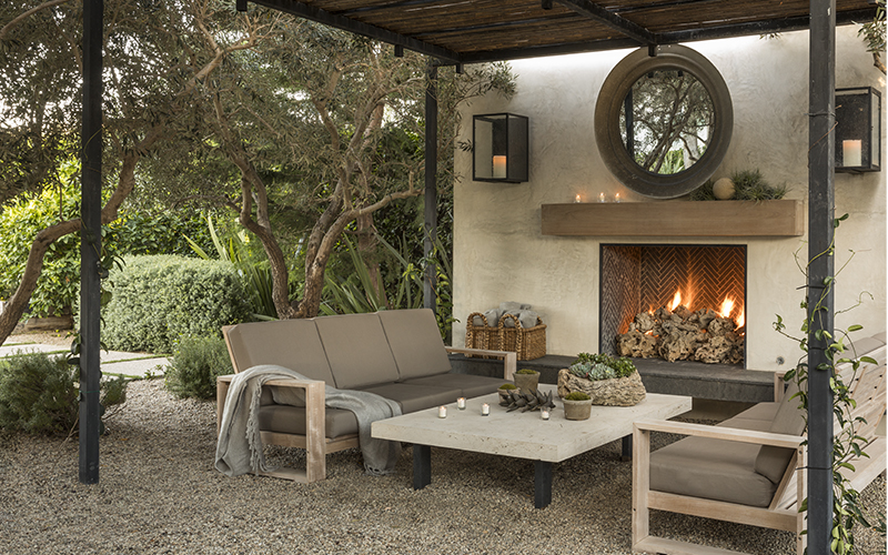 outdoor seating and garden in front of an outdoor fireplace