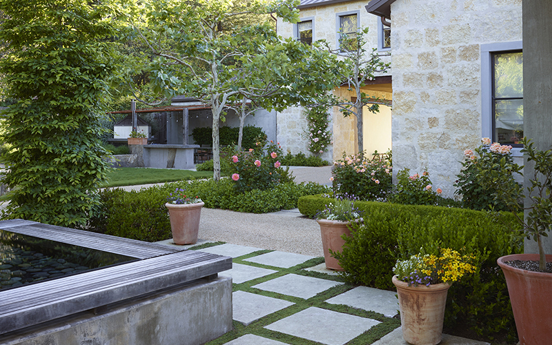 stone patio around a pool feature and terra cotta pots