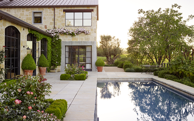 old-world mediterranean garden around a rectangular pool